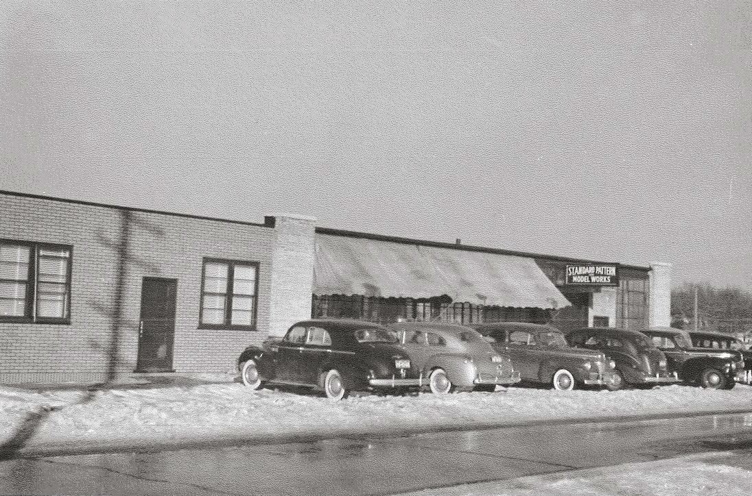 The Standard Pattern Model Works building, Muskegon Heights, with vintage cars parked out front