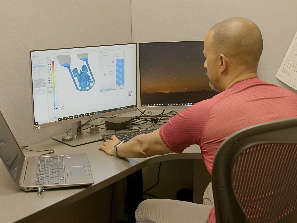 Anderson Global engineer running EKK casting simulation software at a dual-monitor workstation